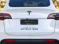 White Tesla Model Y with I Identify As A Datsun 180B decal