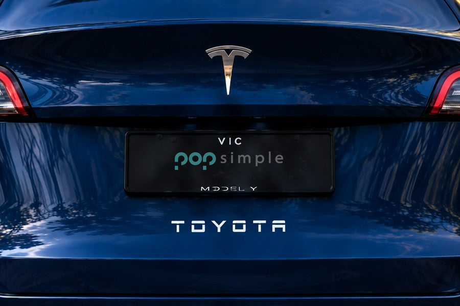 Pop Simple TOYOTA decal centered beneath the number plate on blue Tesla