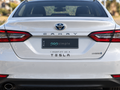 Pop Simple I Identify as a Tesla decal on current-model Toyota Camry — contextual view