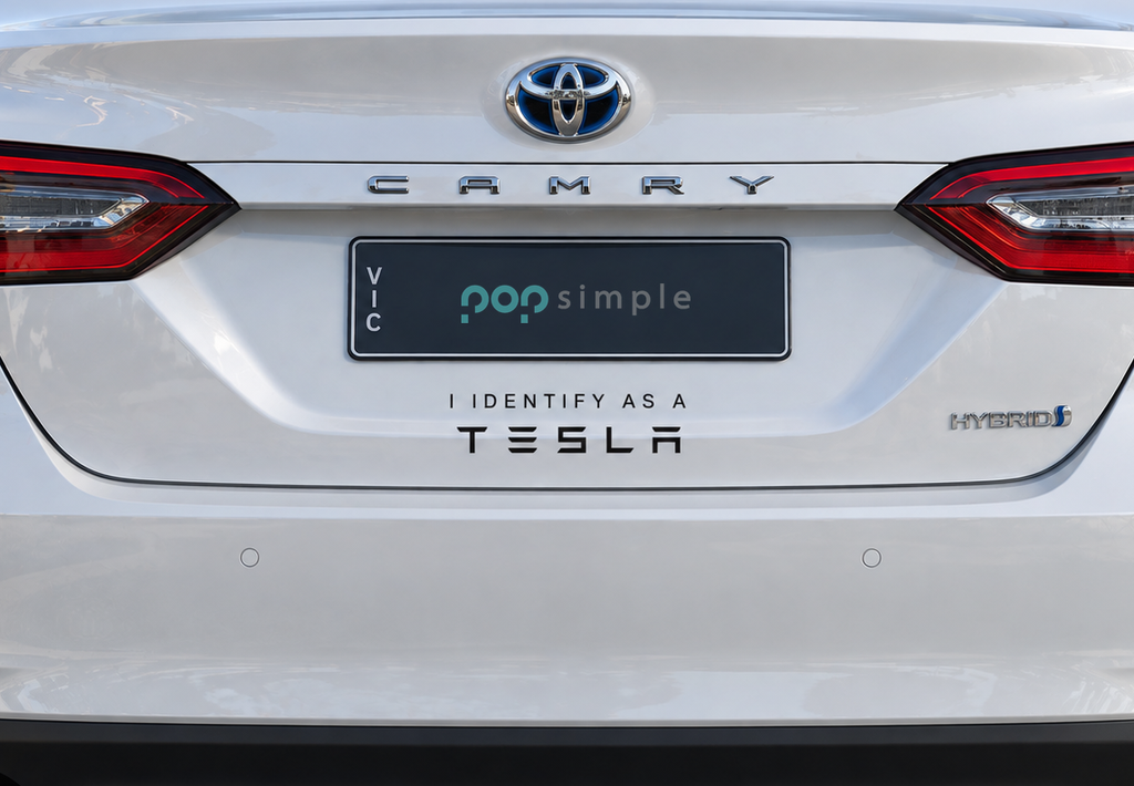 Pop Simple I Identify as a Tesla decal on current-model Toyota Camry — close detail