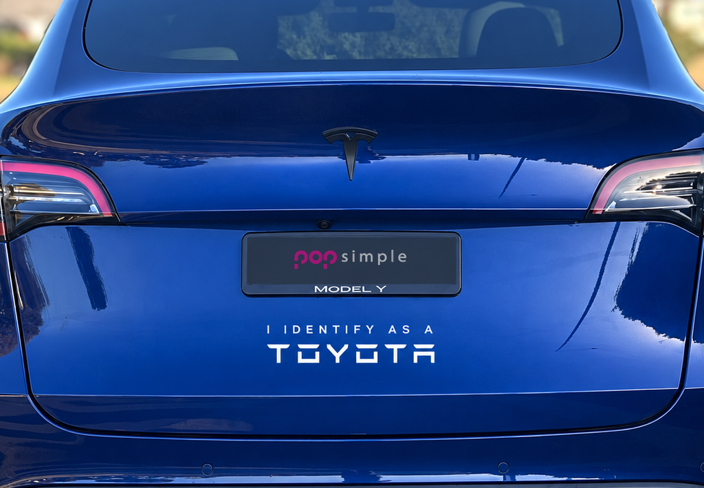 Pop Simple I Identify as a Toyota decal on blue Tesla Model Y — close detail