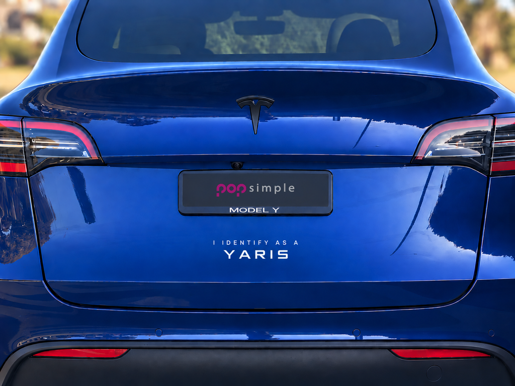 Pop Simple I Identify as a Yaris decal on blue Tesla Model Y — contextual view