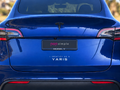 Pop Simple I Identify as a Yaris decal on blue Tesla Model Y — contextual view